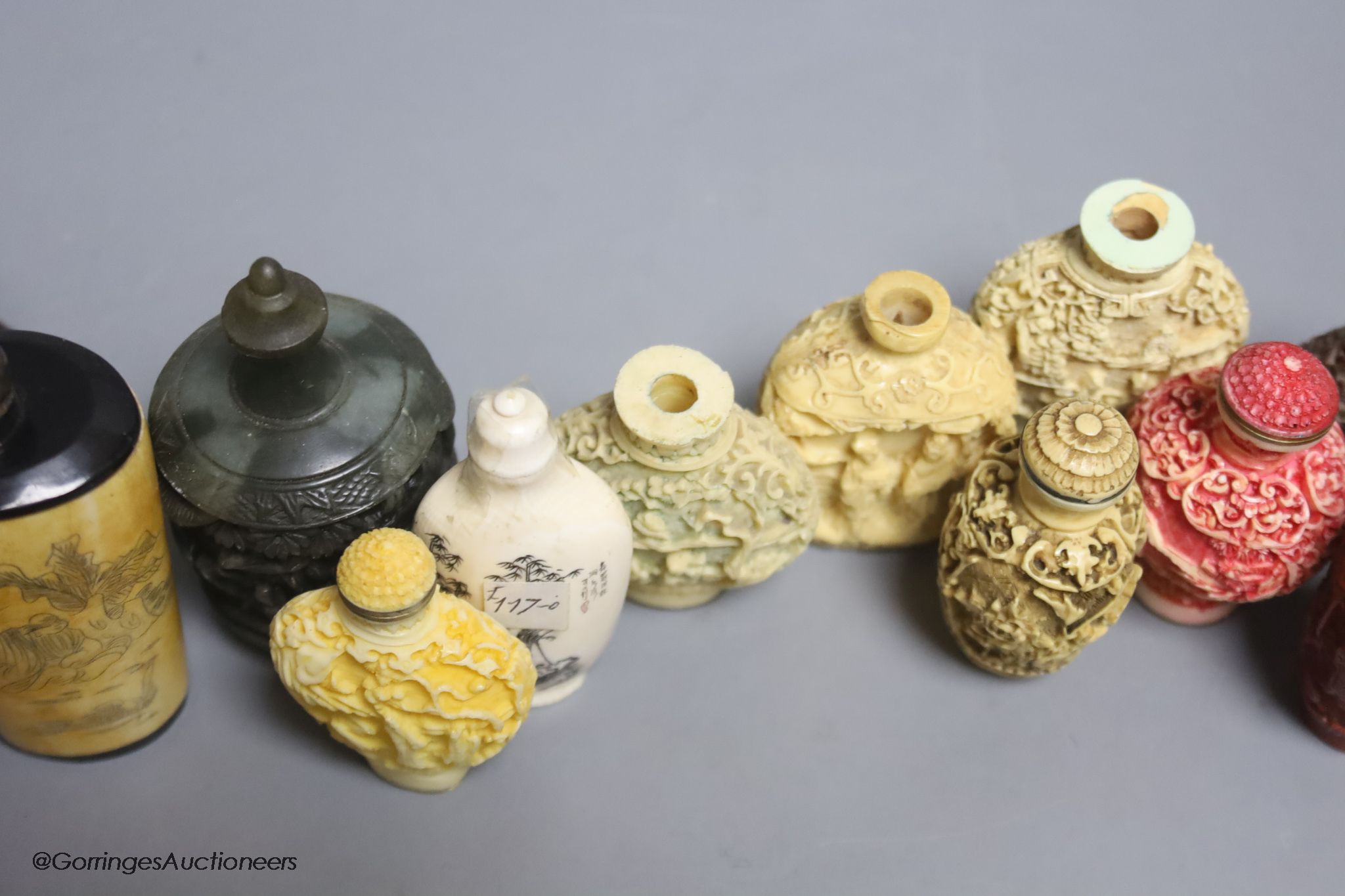 A large Chinese 20th century carved snuff bottle and smaller snuff bottles